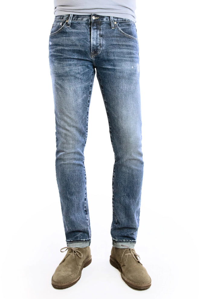 SMN Studio's Hunter in Rouge Men's Jeans - Slim fit jean in medium washed comfort stretch premium Japanese selvedge denim with fades, whiskering, honeycombs, and slight tears for a natural looking vintage wash 