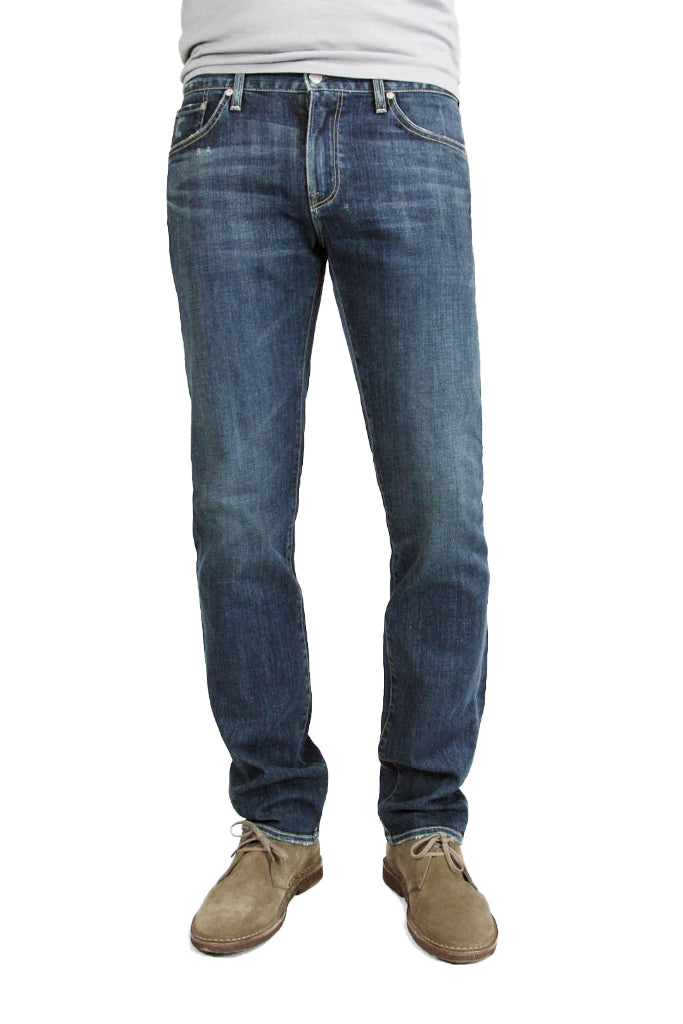 S.M.N Studio's Hunter in Odyssey Men's Jeans - Slim fit medium vintage indigo washed denim contrasted by light fading throughout the jeans including whiskers and honeycombs