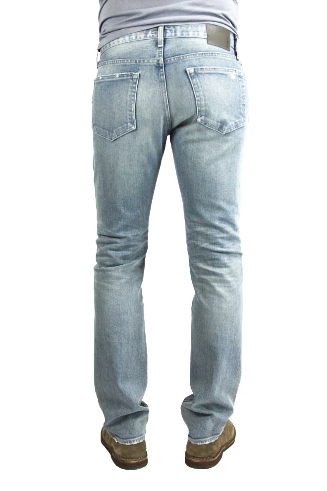 Back of S.M.N Studio's Bond in Vernon Repair men's jeans. A slim straight jean made in a comfort stretch Japanese denim. Its light blue wash is contrasted with fading and repaired distressing around the knees with subtle rip details on the hems of the jeans.