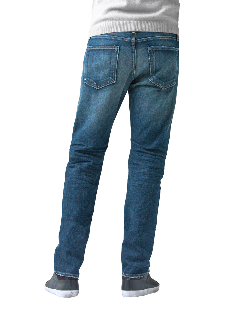 The back of S.M.N Studio's Bond in Sundance Men's Jeans. A slim straight darker blue wash jean accented with contrasting fades and whiskers for a worn in look. It's made in a comfort stretch Japanese denim. 