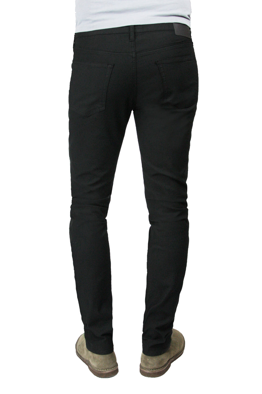 Back of S.M.N Studio's Finn in Black Men's Twill pants in a 30" Inseam. Tapered slim comfort stretch twill pants dyed in black