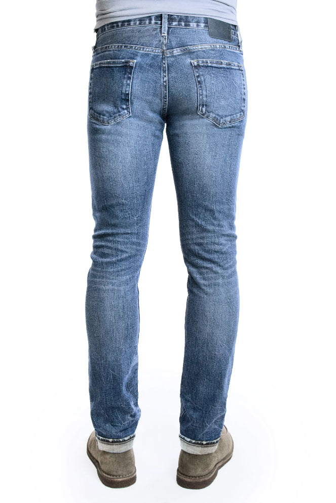 Back of SMN Studio's Hunter in Rouge Men's Jeans - Slim fit jean in medium washed comfort stretch premium Japanese selvedge denim with fades, whiskering, honeycombs, and slight tears for a natural looking vintage wash 