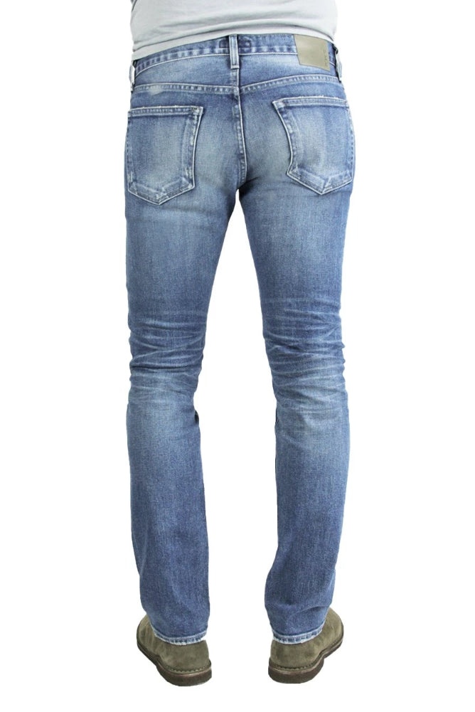 Back of S.M.N Studio's Hunter in Aspen Men's Jeans - Tapered Slim Comfort Stretch Selvedge Denim in vintage medium blue wash with contrasting fades and 3D whiskering