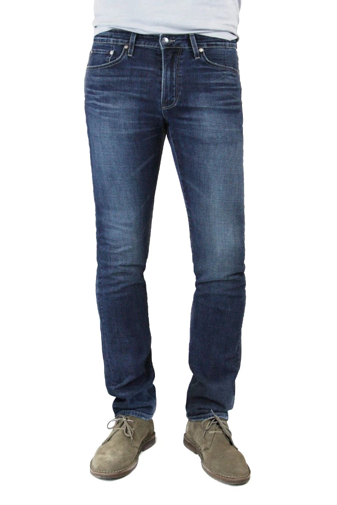 S.M.N Studio's Hunter in Linden Men's Jeans - A slim fit dark indigo washed denim lightly contrasted with fading, whiskering, and honeycombs for a slight worn-in look.