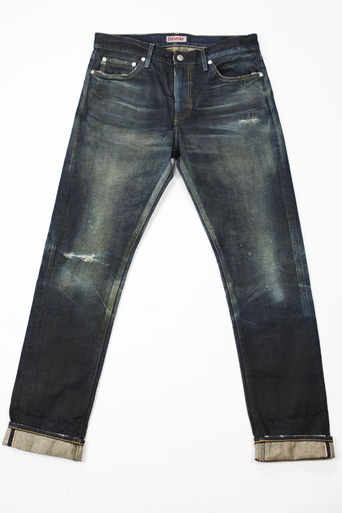 Flat image of S.M.N Studio's Mercer in Deliverance Men's Jeans - A vintage inspired dark washed slim fit jean made in 100% Japanese cotton selvedge with fading and rips