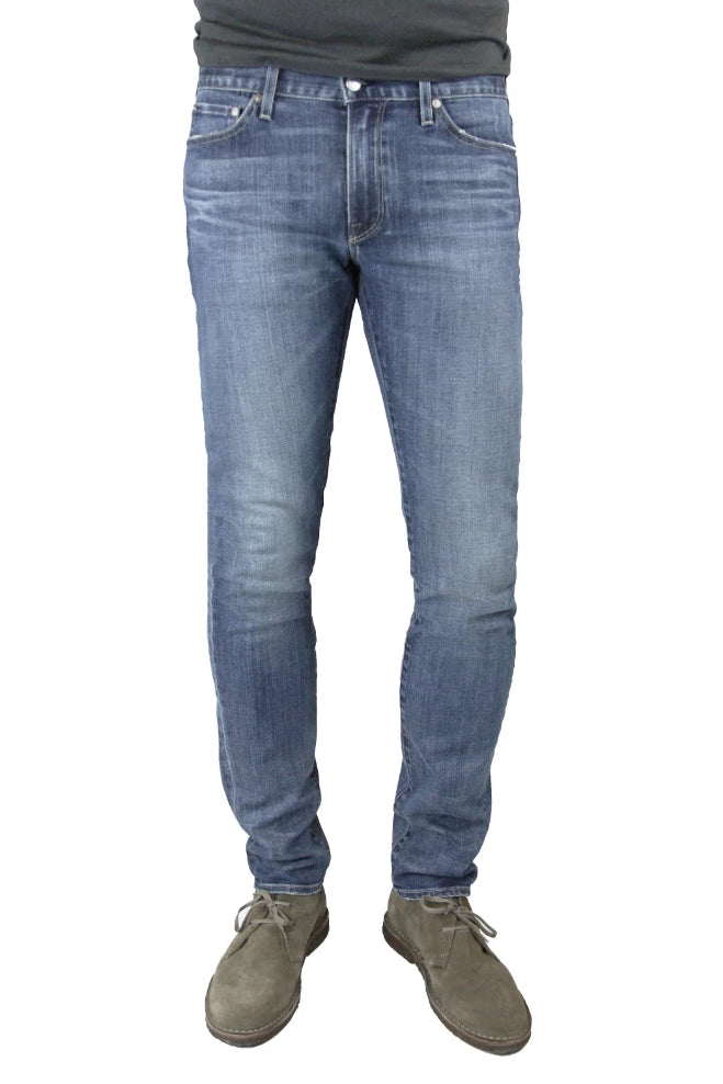S.M.N Studio's Hunter in Archer Men's Jeans - Slim fit jeans in a comfort Stretch Denim that has a medium wash highlighted by slight contrast fades and 3D whiskers
